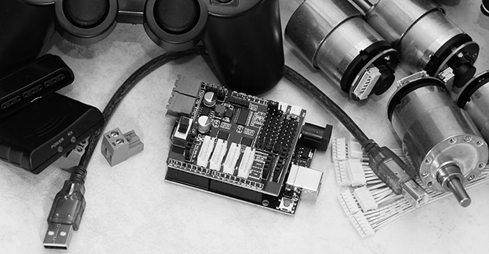 arduino like board with servo shield, stepper motors, ps like black controller with a radio transmitter and wires